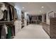Large walk-in closet featuring custom shelving, drawers, and ample storage space at 6173 Rosslyn Ave, Indianapolis, IN 46220