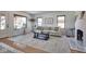 Bright living room featuring a decorative fireplace, large windows, and stylish decor at 6173 Rosslyn Ave, Indianapolis, IN 46220