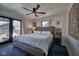 Bright main bedroom with french doors, a large bed, and hardwood floors at 6173 Rosslyn Ave, Indianapolis, IN 46220