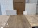 Selection of design materials showcasing tile, wood, and carpet options for interior upgrades at 6702 Thresher Pass, McCordsville, IN 46055