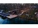 Aerial view of a waterfront home with a dock, boat slips, and landscaped grounds at 7014 Eagle Dr, Nineveh, IN 46164