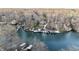 Aerial view showcasing lakefront homes with docks and boat slips surrounded by lush trees at 7014 Eagle Dr, Nineveh, IN 46164