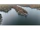 Expansive aerial view of lake houses nestled among trees, offering a serene waterfront lifestyle at 7014 Eagle Dr, Nineveh, IN 46164