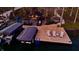 Stunning aerial view of the lakeside entertainment deck featuring a bar, boat dock and lounge chairs at 7014 Eagle Dr, Nineveh, IN 46164
