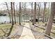 Backyard view with a walking path leading to the lake and boat dock at 7014 Eagle Dr, Nineveh, IN 46164