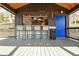 Lakeside bar interior with seating, a television, corrugated metal accents and a vibrant blue door at 7014 Eagle Dr, Nineveh, IN 46164