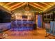 This covered lakeside bar has a wood-slat ceiling, a tv, corrugated metal accents, and great lighting at 7014 Eagle Dr, Nineveh, IN 46164