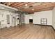 Unfinished basement area with utility access and wood-look flooring at 7014 Eagle Dr, Nineveh, IN 46164