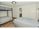 This bedroom offers a bunk bed, a full bed, a door to the hall, and an ensuite bathroom at 7014 Eagle Dr, Nineveh, IN 46164