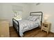 Comfortable bedroom with a metal frame bed, and a window providing natural light at 7014 Eagle Dr, Nineveh, IN 46164