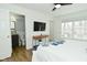 This bright bedroom features a ceiling fan, TV, modern furnishings, and an attached bathroom at 7014 Eagle Dr, Nineveh, IN 46164