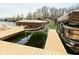 Modern boat dock featuring covered lifts and leisure seating, perfect for enjoying waterfront activities and boat storage at 7014 Eagle Dr, Nineveh, IN 46164