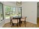 Cozy dining area featuring a round table with four chairs next to a bright window at 7014 Eagle Dr, Nineveh, IN 46164