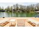 Inviting lakeside dock featuring comfortable lounge chairs and stunning views, ideal for relaxation and waterfront enjoyment at 7014 Eagle Dr, Nineveh, IN 46164