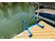 Convenient blue ladder on a wooden dock provides easy access to the refreshing lake water, perfect for swimming at 7014 Eagle Dr, Nineveh, IN 46164
