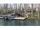 Waterfront property with a private dock featuring boat slips and a lakeside lounging area at 7014 Eagle Dr, Nineveh, IN 46164