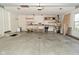 Spacious garage with concrete floor, shelving, storage, and a bright window at 7014 Eagle Dr, Nineveh, IN 46164