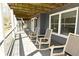 Covered porch with outdoor ceiling and comfortable rocking chairs at 7014 Eagle Dr, Nineveh, IN 46164