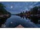 Scenic view of lakefront homes reflecting on the calm water under a stunning sky, capturing tranquil waterfront living at 7014 Eagle Dr, Nineveh, IN 46164