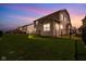 Evening view of backyard with fencing, grassy lawn, and home's exterior at 7128 English Oak Dr, McCordsville, IN 46055