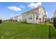 Backyard view featuring manicured lawn, secure fencing, and exterior at 7128 English Oak Dr, McCordsville, IN 46055