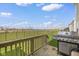 A spacious backyard with a grill on the deck, overlooks a beautiful green space at 7128 English Oak Dr, McCordsville, IN 46055