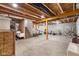 Unfinished basement with exposed wood beams, concrete floor, and installed exercise equipment at 7128 English Oak Dr, McCordsville, IN 46055