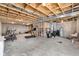 An unfinished basement offers exposed wooden beams, concrete flooring, and ample space at 7128 English Oak Dr, McCordsville, IN 46055