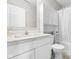 Clean bathroom with white cabinets, a sink and a toilet with an attached cabinet at 7128 English Oak Dr, McCordsville, IN 46055