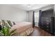 Cozy bedroom features hardwood floors, a TV, and soft pink bedding at 7128 English Oak Dr, McCordsville, IN 46055