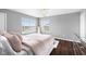 Bright bedroom with hardwood floors, chandelier, and large windows with exterior view at 7128 English Oak Dr, McCordsville, IN 46055