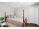 Bright bedroom with hardwood floors, a four-poster bed and fresh white trim at 7128 English Oak Dr, McCordsville, IN 46055
