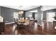 This spacious dining area with stylish wood flooring flows seamlessly into a comfortable living space at 7128 English Oak Dr, McCordsville, IN 46055