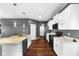 Well-equipped kitchen featuring stainless steel appliances, white cabinetry, hardwood floors, and center island at 7128 English Oak Dr, McCordsville, IN 46055