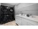 Functional laundry room equipped with a washer/dryer, sink, cabinet and shelving at 7128 English Oak Dr, McCordsville, IN 46055