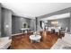 Spacious living area showcases hardwood floors, gray walls, an open layout, plus an adjacent dining area at 7128 English Oak Dr, McCordsville, IN 46055