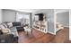 Cozy living room with a large sectional sofa, bookshelf, and hardwood floors at 7128 English Oak Dr, McCordsville, IN 46055