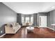 Elegant living space with hardwood floors, gray walls, stylish decor, and a bright, welcoming ambiance at 7128 English Oak Dr, McCordsville, IN 46055