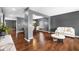 Expansive open-concept living space with hardwood floors, gray walls, plus seamless transition into the dining area at 7128 English Oak Dr, McCordsville, IN 46055