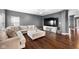 Bright living room showcases a large sectional sofa, entertainment center and an airy open floor plan at 7128 English Oak Dr, McCordsville, IN 46055