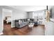 Comfortable living room with a gray sofa, hardwood floors, and lots of natural light at 7128 English Oak Dr, McCordsville, IN 46055