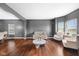 Bright, open-concept living room with hardwood floors, neutral paint, and stylish furniture, flooded with natural light at 7128 English Oak Dr, McCordsville, IN 46055