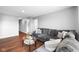 Comfortable living room with modern furnishings, hardwood floors, and neutral color palette at 7128 English Oak Dr, McCordsville, IN 46055