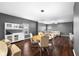 Open living space with a dining area flowing into a comfortable living room with large sectional sofa at 7128 English Oak Dr, McCordsville, IN 46055