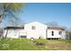 A spacious backyard featuring a detached garage, with a tree swing set at 7838 Burr Oak Ct, Indianapolis, IN 46217