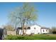 Backyard featuring a large tree, a detached garage, and a swing set at 7838 Burr Oak Ct, Indianapolis, IN 46217