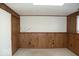 Basement area featuring paneled walls and carpeting provides a versatile living space at 7838 Burr Oak Ct, Indianapolis, IN 46217