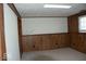 Spacious basement area featuring paneled walls and carpeting provides a versatile living space at 7838 Burr Oak Ct, Indianapolis, IN 46217