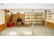 Unfinished basement with carpet, wood paneling, shelving, and support beam at 7838 Burr Oak Ct, Indianapolis, IN 46217