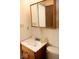 Bathroom showcasing a wood vanity with sink and toilet; a mirrored cabinet is above the sink at 7838 Burr Oak Ct, Indianapolis, IN 46217